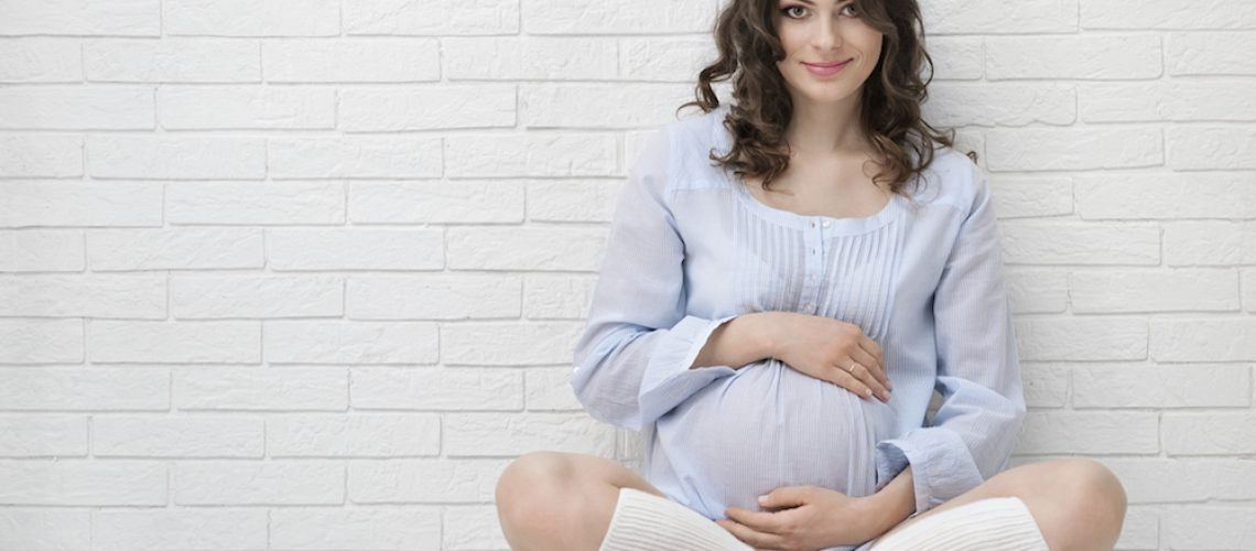 Portrait of the young pregnant woman